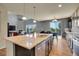 Well-lit kitchen showcasing a large island, modern appliances, and an open layout, perfect for culinary enthusiasts at 428 Starline Ave, Lafayette, CO 80026