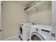 Modern laundry room with white washer and dryer and convenient shelving for storage at 428 Starline Ave, Lafayette, CO 80026