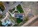 Stunning aerial view showcasing a modern home with solar panels, lush landscaping, and a detached structure on a spacious lot at 17326 W 57Th Ave, Golden, CO 80403