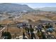 Panoramic aerial view of a hillside property, nestled within a tranquil landscape surrounded by a scenic mountain backdrop at 17326 W 57Th Ave, Golden, CO 80403