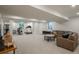 Finished basement with home gym, living area, neutral carpet and ample natural light at 17326 W 57Th Ave, Golden, CO 80403