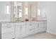 Bathroom featuring a double vanity with framed mirrors and sconces at 17326 W 57Th Ave, Golden, CO 80403