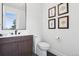 Modern bathroom featuring a stylish vanity, toilet and wall art at 17326 W 57Th Ave, Golden, CO 80403