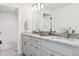 Elegant bathroom features a double vanity with granite countertop and modern fixtures with an adjacent shower at 17326 W 57Th Ave, Golden, CO 80403
