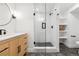 Modern bathroom featuring a glass shower, wood vanity, and sleek fixtures, exuding minimalist elegance at 17326 W 57Th Ave, Golden, CO 80403