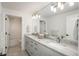 Modern bathroom with a double vanity, granite countertop, and updated fixtures at 17326 W 57Th Ave, Golden, CO 80403