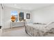Serene bedroom features a cozy bed, bright window with outdoor views and a modern lamp on a sleek table at 17326 W 57Th Ave, Golden, CO 80403