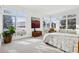 Sunlit bedroom with neutral tones, large windows, and elegant furnishings offer a serene retreat at 17326 W 57Th Ave, Golden, CO 80403