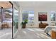 Airy bedroom with large windows and access to an outdoor patio overlooking a snowy landscape at 17326 W 57Th Ave, Golden, CO 80403