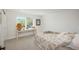 Bright bedroom with a large window, console table, and comfortable decor at 17326 W 57Th Ave, Golden, CO 80403