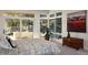 Bright bedroom featuring a large window, stylish decor, and access to outdoor space at 17326 W 57Th Ave, Golden, CO 80403