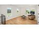 Spacious bonus room with hardwood floors, chair, and tranquil outdoor views at 17326 W 57Th Ave, Golden, CO 80403