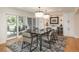 Elegant dining room featuring modern light fixtures, stylish furniture, and sliding doors leading to the outdoor patio at 17326 W 57Th Ave, Golden, CO 80403