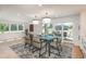 Elegant dining room featuring modern lighting, stylish furniture, and access to outdoor patio at 17326 W 57Th Ave, Golden, CO 80403