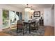 Elegant dining room with modern lighting, stylish chairs, and access to an outdoor patio at 17326 W 57Th Ave, Golden, CO 80403
