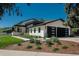 Contemporary home featuring a black two-car garage, lush landscaping, stone accents, and a well-manicured lawn at 17326 W 57Th Ave, Golden, CO 80403