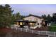 Modern home features clean white lines, dark accents, large windows, and verdant landscaping at 17326 W 57Th Ave, Golden, CO 80403