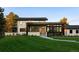 Contemporary home showcasing clean lines, stone accents, and meticulous landscaping at 17326 W 57Th Ave, Golden, CO 80403