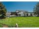Modern two-story home with manicured lawn, sleek design, and mature trees at 17326 W 57Th Ave, Golden, CO 80403