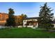 Stunning modern home boasting lush lawn, mature trees, and mountain views at 17326 W 57Th Ave, Golden, CO 80403
