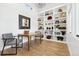 Home office features custom shelving and wooden floors at 17326 W 57Th Ave, Golden, CO 80403