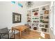 Bright home office with custom built-in shelving, wood floors, and modern decor at 17326 W 57Th Ave, Golden, CO 80403