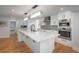 Bright kitchen with quartz countertops, stainless steel appliances, and hardwood flooring at 17326 W 57Th Ave, Golden, CO 80403