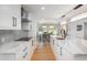 Bright kitchen with quartz countertops, stainless steel appliances, and hardwood flooring at 17326 W 57Th Ave, Golden, CO 80403