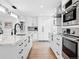 Sleek kitchen featuring modern white cabinetry, a large island, and hardwood floors at 17326 W 57Th Ave, Golden, CO 80403