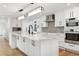 Bright kitchen with white cabinets, marble countertops, and stainless steel appliances at 17326 W 57Th Ave, Golden, CO 80403
