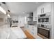 Bright kitchen with quartz countertops, stainless steel appliances, and hardwood flooring at 17326 W 57Th Ave, Golden, CO 80403