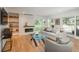 Bright living room featuring hardwood floors, a modern fireplace, and comfortable seating, offering a cozy and stylish space at 17326 W 57Th Ave, Golden, CO 80403