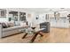 Spacious living area with a comfortable sofa, glass coffee table, and open access to the kitchen at 17326 W 57Th Ave, Golden, CO 80403
