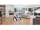 Living room featuring a modern fireplace, expansive windows, and comfortable seating at 17326 W 57Th Ave, Golden, CO 80403