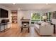 Bright living room with a fireplace, hardwood floors, and a view of the outdoors at 17326 W 57Th Ave, Golden, CO 80403