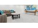 Spacious living room features comfortable seating, stylish coffee table, and a decorative world map at 17326 W 57Th Ave, Golden, CO 80403