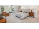 Spacious main bedroom featuring a decorative bed, a leather chair, and natural light at 17326 W 57Th Ave, Golden, CO 80403