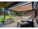 Comfortable outdoor patio featuring modern pergola, stone accents, and ample seating at 17326 W 57Th Ave, Golden, CO 80403