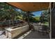 Charming outdoor patio area with stone accents, comfortable seating, and views of the landscaped greenery at 17326 W 57Th Ave, Golden, CO 80403