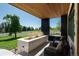 Inviting porch featuring a stone planter, comfortable seating, and views of the well-manicured lawn and open surroundings at 17326 W 57Th Ave, Golden, CO 80403