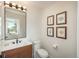 Elegant powder room featuring a stylish vanity, decorative art, and contemporary fixtures at 17326 W 57Th Ave, Golden, CO 80403