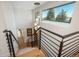 Modern staircase with black railing and large window offering scenic views at 17326 W 57Th Ave, Golden, CO 80403