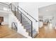 Modern staircase with black iron railings and patterned carpet runner at 17326 W 57Th Ave, Golden, CO 80403