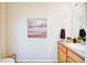 This half bathroom features an art piece, a sink, and a beautiful hardwood floor at 13033 Grant E Cir # B, Thornton, CO 80241