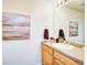 This half bathroom features an art piece, a sink, and a beautiful hardwood floor at 13033 Grant E Cir # B, Thornton, CO 80241