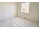 A bright bedroom with carpet and a large window for ample natural light at 13033 Grant E Cir # B, Thornton, CO 80241