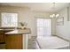 Bright dining room features an adjacent kitchen, natural light, and hardwood floors at 13033 Grant E Cir # B, Thornton, CO 80241