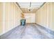 Spacious garage with shelving units, storage and overhead lighting, ideal for parking and projects at 13033 Grant E Cir # B, Thornton, CO 80241