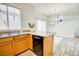 Kitchen featuring a breakfast bar, stainless sink, and an adjacent dining area at 13033 Grant E Cir # B, Thornton, CO 80241