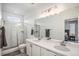 Modern bathroom with double vanity, large mirror, and a walk-in shower at 24257 E 41St Ave, Aurora, CO 80019